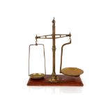 A set of 19th Century brass beam tea scales, and some weights on mahogany base, stamped Morgan,