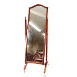 A good quality mahogany cheval mirror, the stand surmounted by urn finials, out swept supports