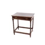 An antique oak side table, fitted with a single drawer raised on bobbin turned supports united by