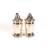 A small pair of George V silver salt and pepper pots, Chester 1911