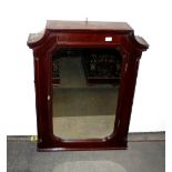 A 19th Century mahogany hanging wall cabinet, having arched pediment, mirrored panel door within