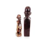 Two carved hardwood and mother of pearl inlaid Ethnic figures