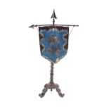 An unusual Victorian rosewood pole screen, of arrow form, having beaded shield shaped banner, raised