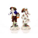 A pair of Dresden style porcelain fruit seller figures, 24cm high