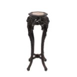 A Chinese carved hardwood plant stand, with foliate and dragon decoration the octagonal top with