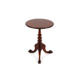 A Victorian mahogany tripod table, the circular top raised on ta turned baluster column and carved