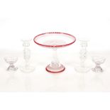 A Victorian cut glass cake or jelly stand, with ruby edging, 26cm dia.; a pair of oval shaped cut