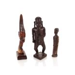 A collection of three African carved hardwood figures, the largest 22cm high