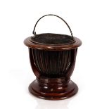 A mahogany basket shaped jardinière, fitted with a brass liner, 36cm high x 37cm dia.