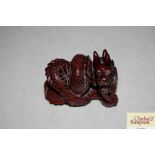 A Chinese carved wooden dragon Netsuke