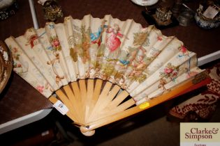 A large fan with boxwood sticks, the printed fabri