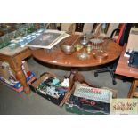 A mahogany oval topped pedestal table