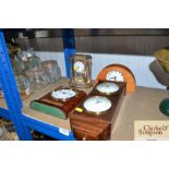 A clock barometer and three mantel clocks