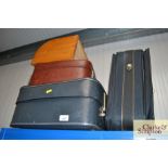 Three suitcases and a bread bin