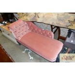 A pink upholstered chaise lounge