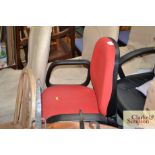 A red upholstered swivel office chair AF