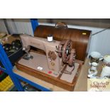 A Singer hand sewing machine in fitted case