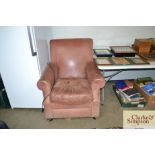 A brown leather upholstered arm chair