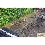 A folding metal garden table and four chairs