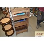 An oak open fronted bookcase with magazine trough