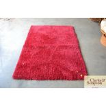 An approximate 5'5" x 3'9" modern wool rug