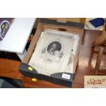 A box containing various black and white prints et