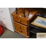 A pine bedside chest fitted three drawers