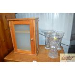 Three glass vases and a wooden wall cabinet