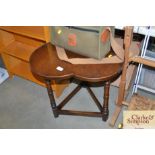 A mahogany side table with clover shaped top