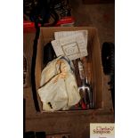 A box of various hand tools and a pair of straps