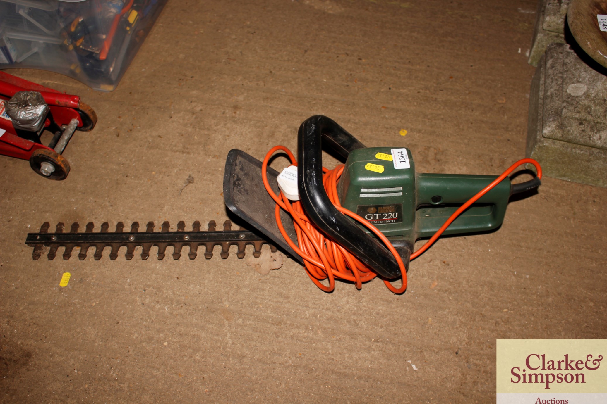 A Black & Decker electric hedge trimmer