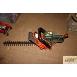 A Black & Decker electric hedge trimmer