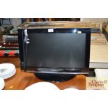 A Toshiba flat screen television with remote contr