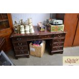 A twin pedestal mahogany desk with red leather ins