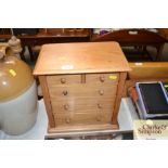 A stripped pine table top chest fitted two short o