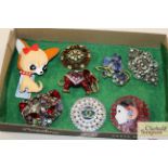 A box of various brooches, some Art Deco