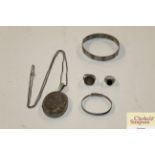 Two white metal bangles, locket etc.