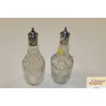 A pair of antique cut glass oil bottles with white