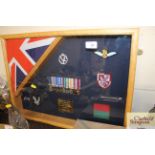 A framed collection of miniature medals and badges