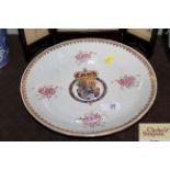 An Armorial saucer dish decorated with the Arms of