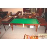 A mahogany snooker dining table with accessories