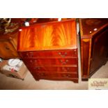A reproduction mahogany four drawer bureau