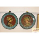 A pair of decorated brass plaques depicting boy an