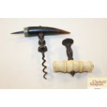 An ivory handled part corkscrew; and another corks