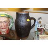 A Royal Doulton leather "Jack" jug with silver rim