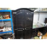 A grey and black painted two door wardrobe