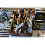 A box containing various hand tools and gardening