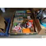 A box containing various games, advertising tins,