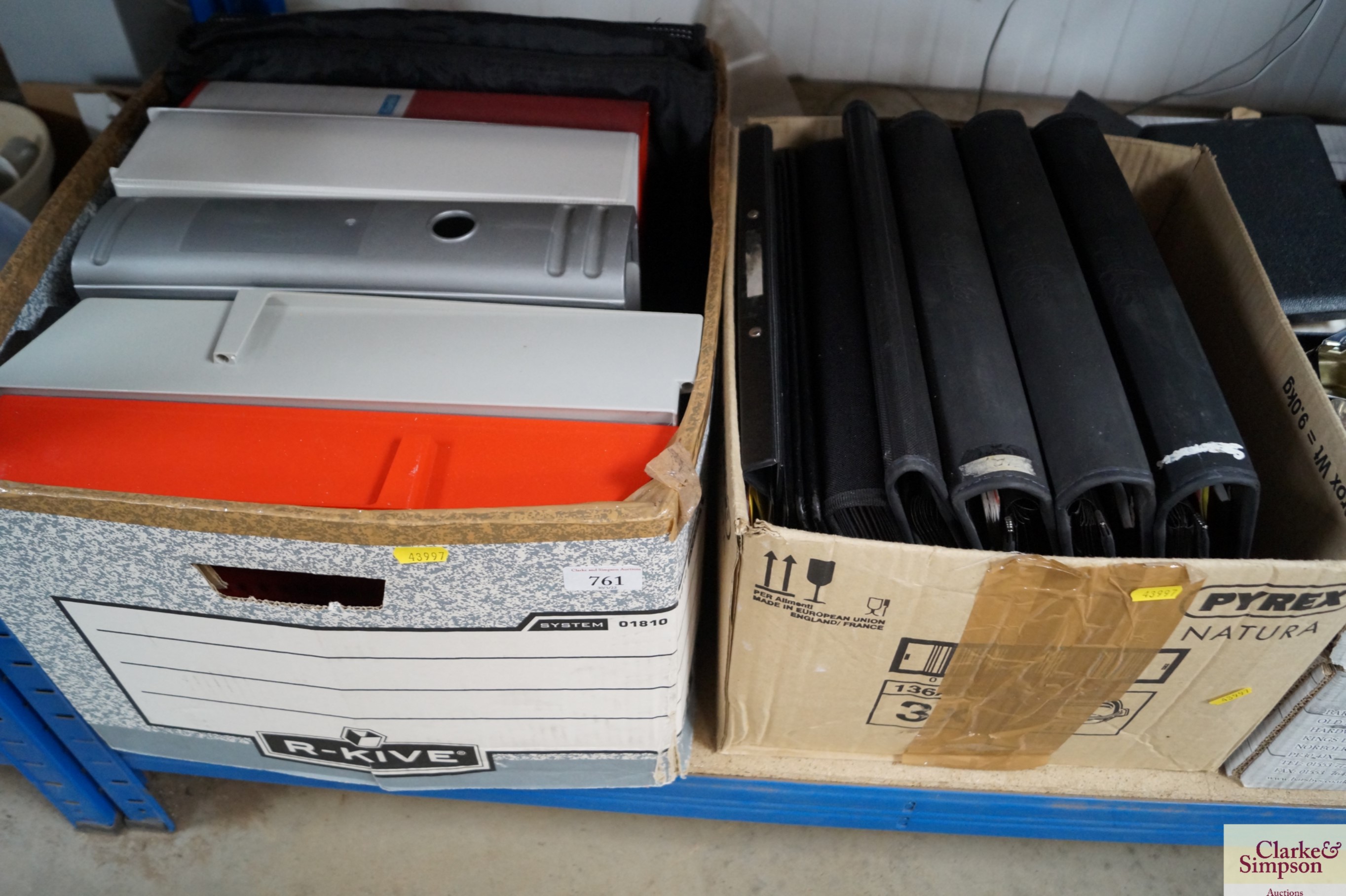 A box of various folders and paperwork holders