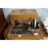A Frister & Rossmann sewing machine with marquetry inlaid case
